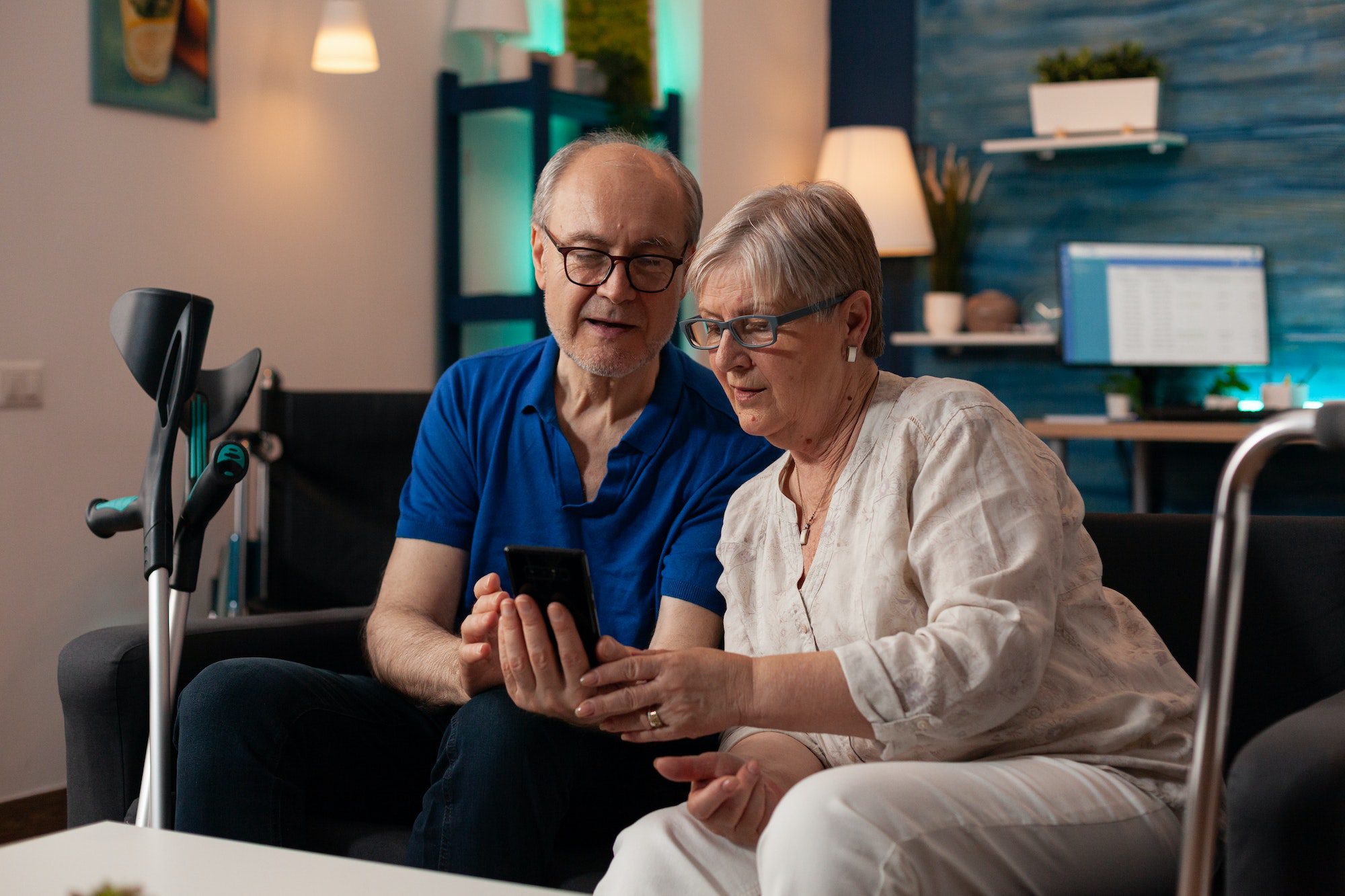 Old man and woman looking at smartphone screen
